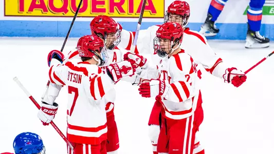 Quinn Hutson, Luke Tuch, Ty Gallagher and Macklin Celebrini celebrate a goal against UMass Lowell