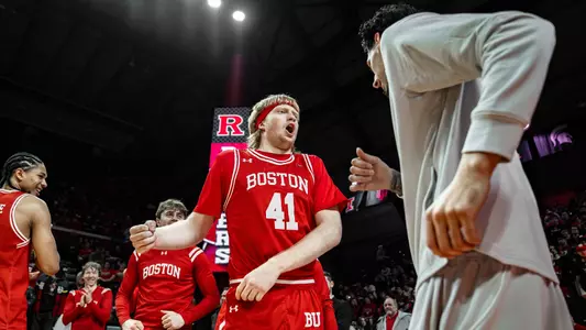 Otto Landrum is greeted by Anthony Morales at the end of the tunnel during the starting lineup announcements at Rutgers.