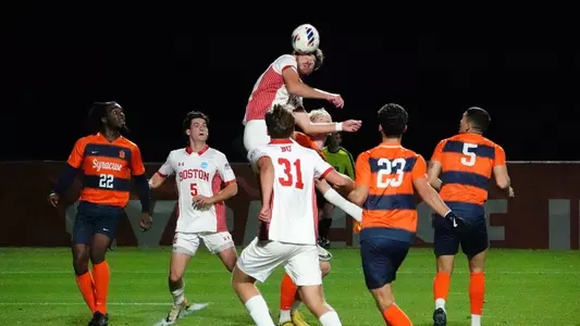 John Roman jumps to head the ball during a scrum at Syracuse.