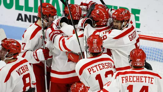 BU men's hockey players celebrating together after a win