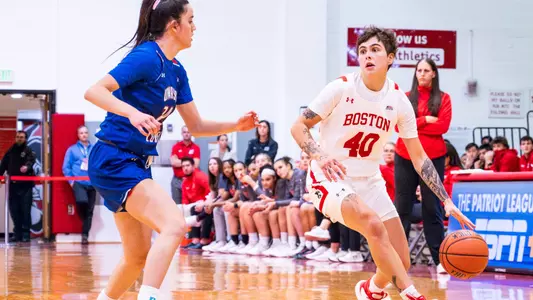 Photo of women's basketball senior Sophie Beneventine dribbling the ball against a UMass Lowell defender.