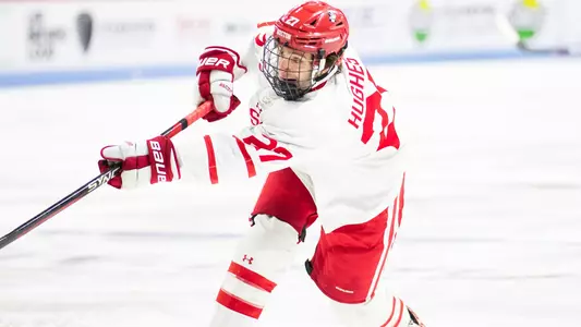 Jack Hughes shooting a puck
