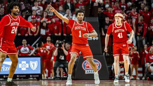 Ethan Okwuosa points forward as BU gets into defensive position with Miles Brewster and Otto Landrum in the background.