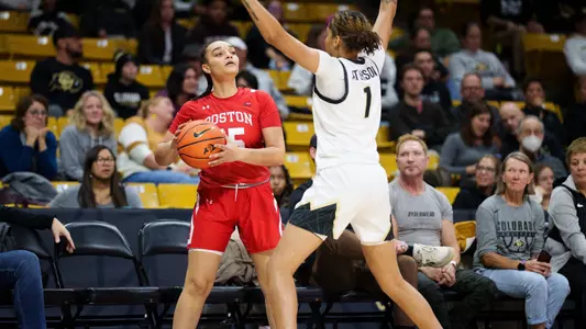 Photo of women's basketball freshman Emelia O'Gilvie looking to pass the ball against Colorado.