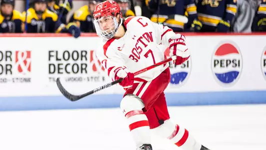 Case McCarthy shooting the puck