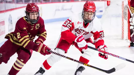 Wilmer Skoog skates next to a BC player