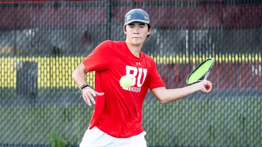 Corey Craig is in the middle of his forehand swing as a tennis ball approaches