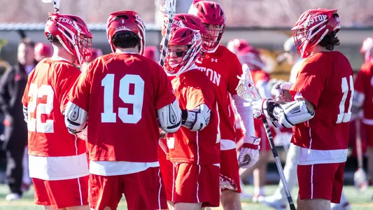 The men's lacrosse team celebrates a goal