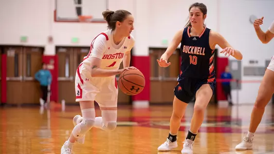 Photo of women's basketball senior Liz Shean dribbling the ball against a Bucknell defender.