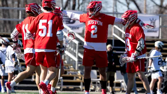 The men's lacrosse team celebrates a goal