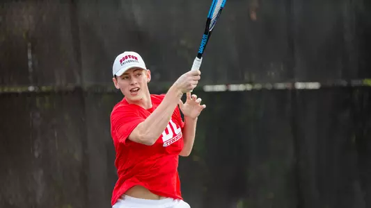 Cole Knutsen follows through on a forehand shot with his racquet