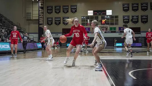 Photo of women's basketball sophomore Lauren Davenport driving against a Black Knight defender.
