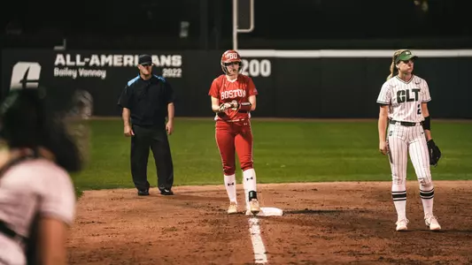 A BU softball runner is standing a third at Charlotte.