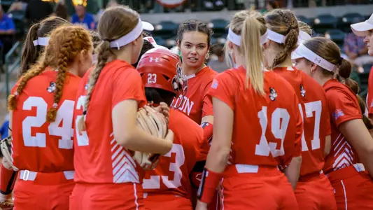 Softball team huddles together in a closed circle at South Florida.