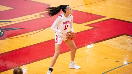Photo of women's basketball junior Caitlin Weimar looking to pass the ball.