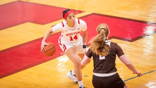 Photo of women's basketball senior Sydney Johnson doing a crossover dribble.