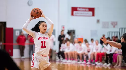 Photo of women's basketball junior Caitlin Weimar holding the ball over her head.