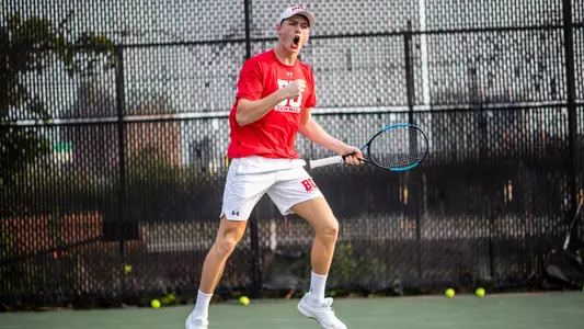Cole Knutsen gives a fist pump after winning a point in singles action