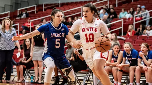 Photo of women's basketball sophomore Alex Giannaros dribbling down the baseline.