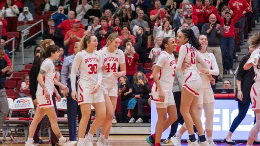 Photo of the women's basketball team celebrating its win over Army in the PL Semifinal.