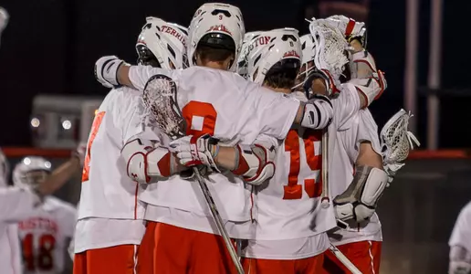 Men's lacrosse players huddling