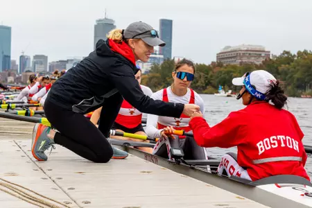 Madeline Davis Tully fist bumping a Terrier student-athlete.