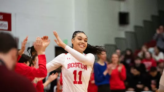 Photo of women's basketball junior Caitlin Weimar high-fiving a teammate during lineup introductions.