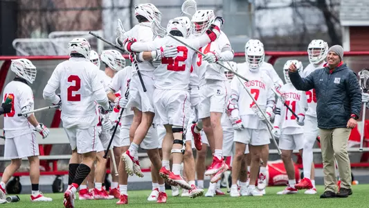 Jake Cates celebrates a goal with his teammates on the sideline