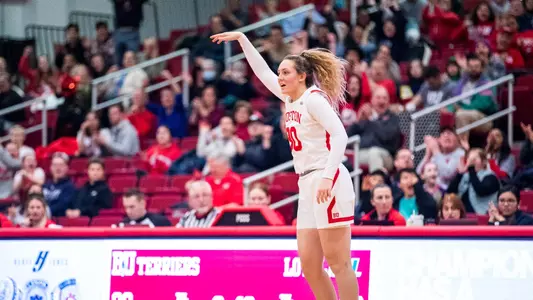 Photo of women's basketball sophomore Lauren Davenport celebrating a three-pointer.