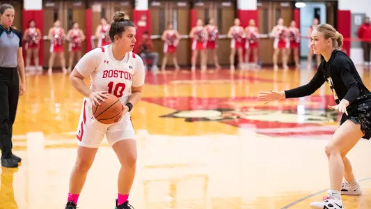 Photo of women's basketball sophomore Alex Giannaros prepares to drive against an Army West Point defender.