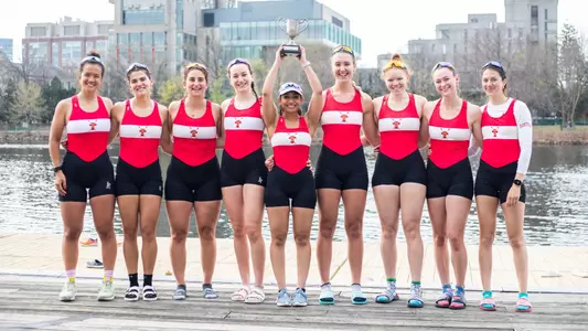 Photo of the Women's Rowing V8 hoisting the Council Cup.
