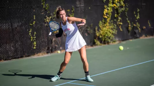 Michelle Kleynerman winds up to hit a forehand at the baseline