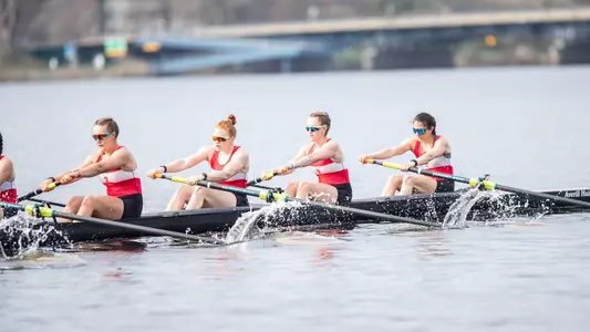 Photo of the BU Women's Rowing V8 racing against Northeastern.