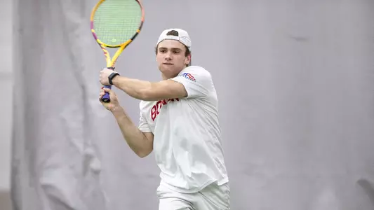 Ben Letzer follows through on a double backhand while wearing his hat backwards.