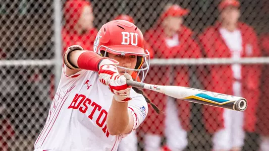 Lauren Keleher sticks a bat out while practicing a swing before facing a pitch at home.