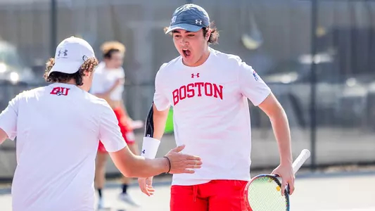 Alejandro Licea gives out a yell and is about to high five Dion Loutas after winning a point in doubles