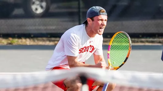 Ben Letzer crouches down after winning his singles match.