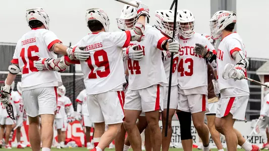 The men's lacrosse team celebrates a goal
