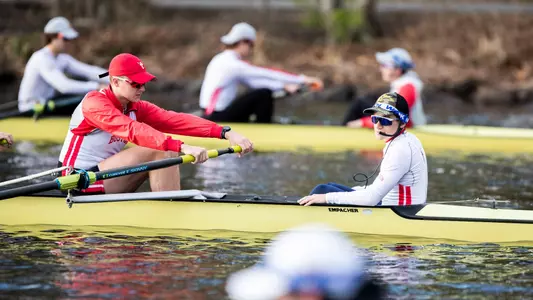 Photo of men's rowing senior coxswain Philip Melki guiding a crew during practice.