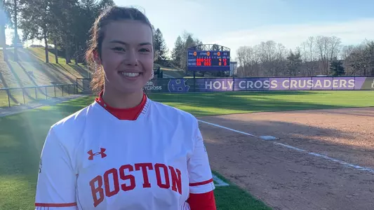 Kasey Ricard stands in front of the Holy Cross scoreboard after pitching her first career no-hitter