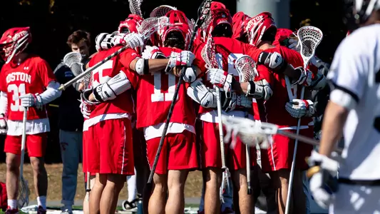The men's lacrosse team huddles before a game