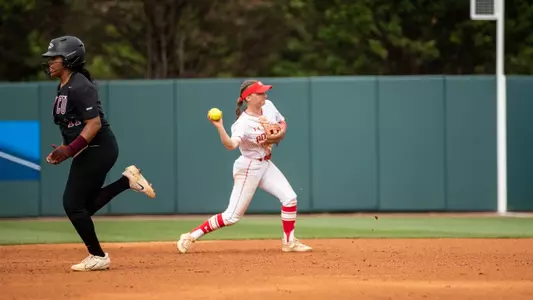 Brooke Deppiesse throws the ball at second to first for a ground out