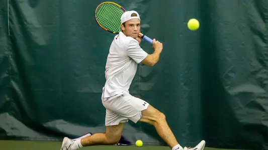 Ben Letzer gets in position for a backhand shot as a ball bounces high in front of him.