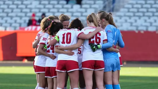 Photo of a women's soccer team huddle during a spring 2023 game at Nickerson Field.