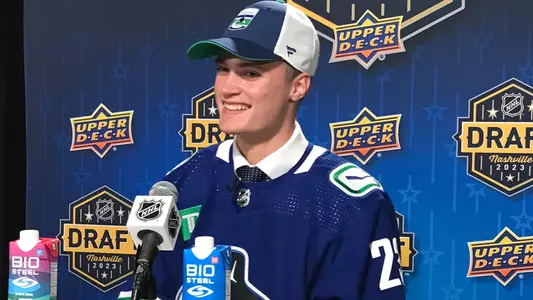 Tom Willander smiling while taking questions from the media at the NHL Draft