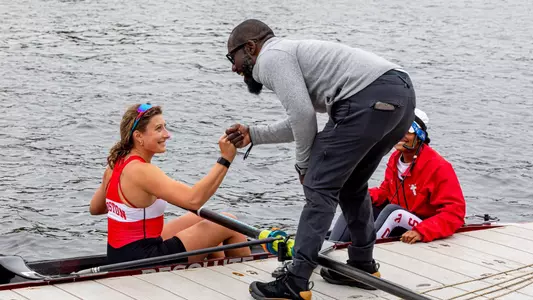 Malcolm Doldron fist bumps a Terrier student-athlete.