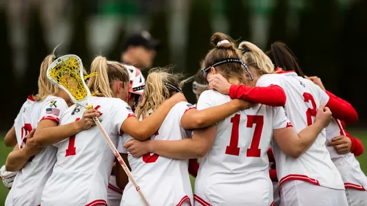 Photo of the women's lacrosse team huddling during the Senior Day contest against Bucknell at Nickerson Field.