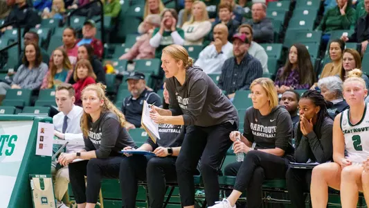 Photo of newly-hired women's basketball assistant coach Jamie Insel giving directions on the Dartmouth sideline.