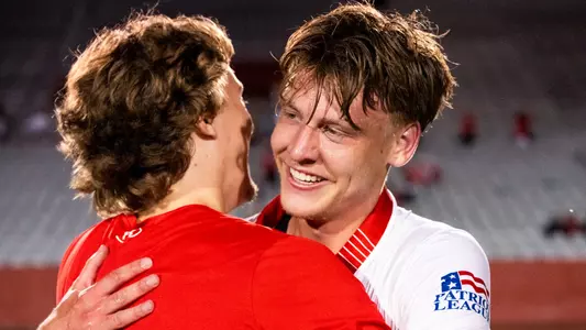 Aidan Bone hugs a teammate with a big smile after scoring the game-winning goal against Albany.
