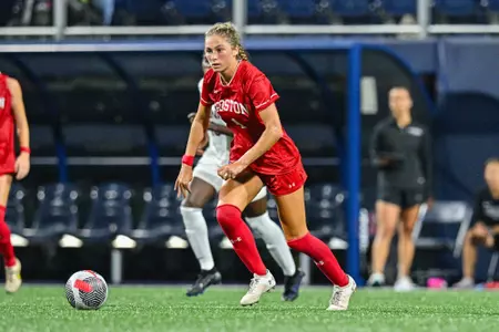 Photo of Mackenzie Stickelman dribbling the ball at UConn.
